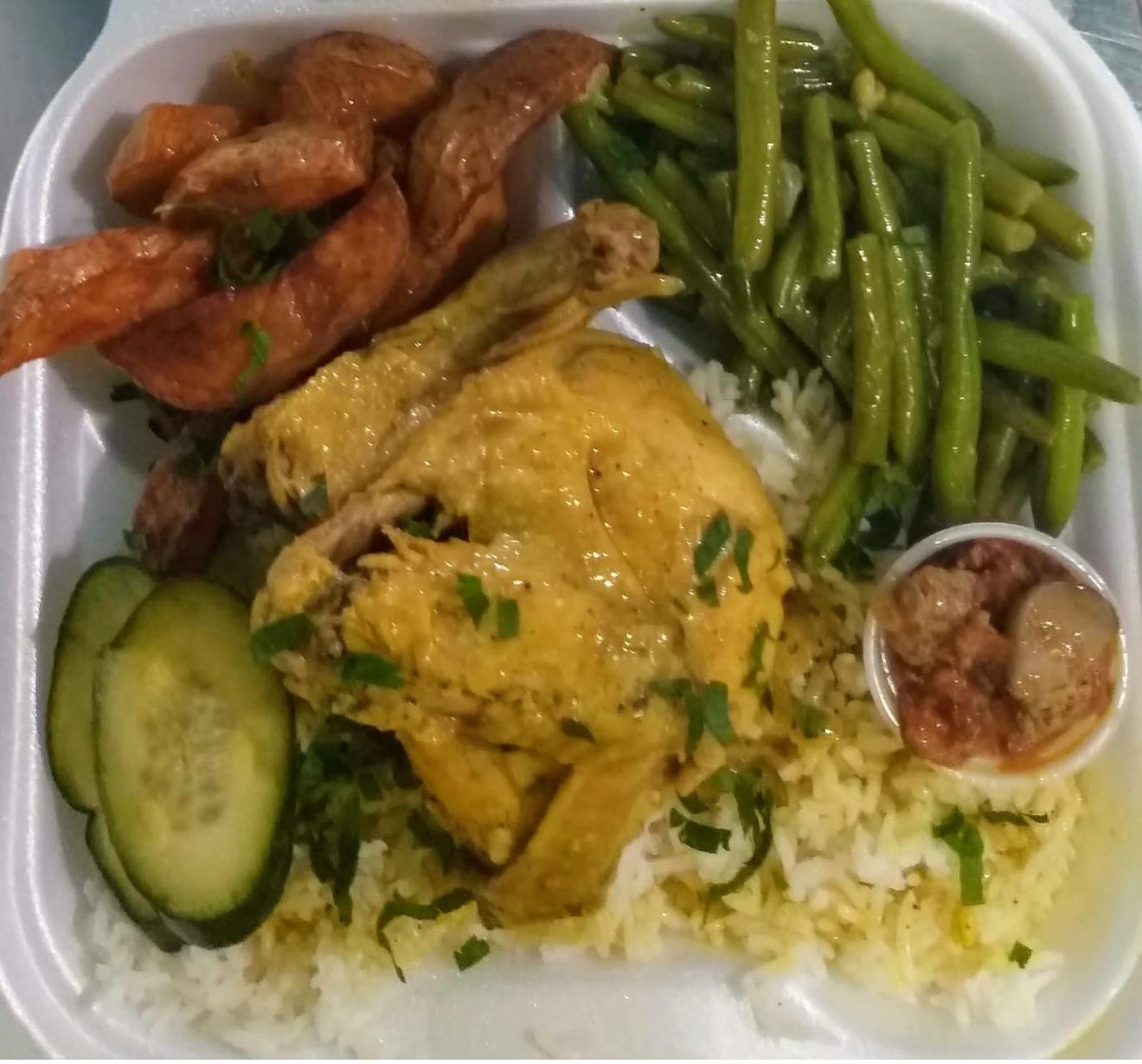 Yellow chicken served with yellow rice 